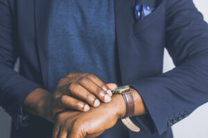 man in suit looking at watch